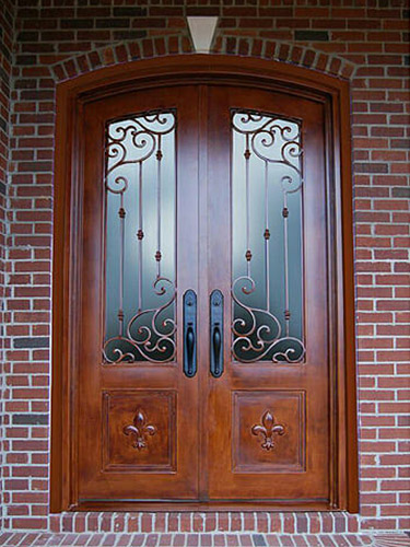 wooden double doors set against brick exterior